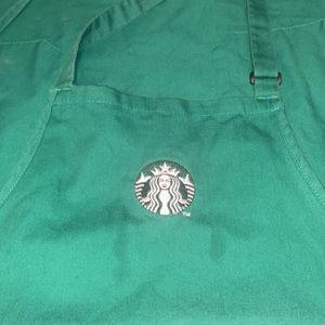 2 Starbucks aprons and a Starbucks hat